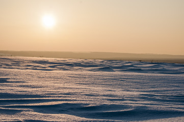 Fototapeta na wymiar sunset against the snow, winter landscape