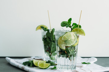 Mojito cocktail with lime and mint in highball glasses