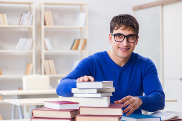 Male student preparing for exams in college library