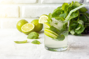 Mojito Cubano (caipirinha cocktail) at sunlight. Summer drink with ice, lime and mint. 