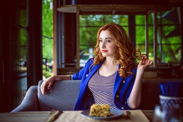 Pretty young woman sitting at yachting club beach restaurant, enjoying tasty breakfast. Summer luxury vacation. 