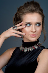 Beauty girl portrait. Makeup. Jewelry. Beautiful woman with hairstyle and evening make-up.