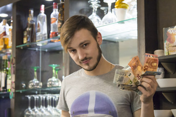 waiter in the pub with money, euro bills