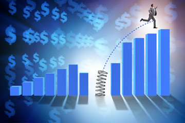 Business people jumping over bar charts