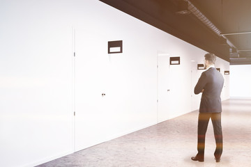Man in white office college corridor doors side