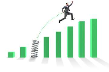 Business people jumping over bar charts