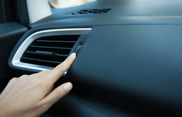 Using hand for adjust  air conditioning temperature level in the car,Black air condition in car