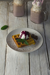 Fototapeta na wymiar waffles with ice cream, milkshake, chocolate and fruit jam
