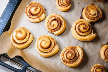 Freshly baked cinnamon buns Kanelbule - swedish dessert with spices on parchment paper