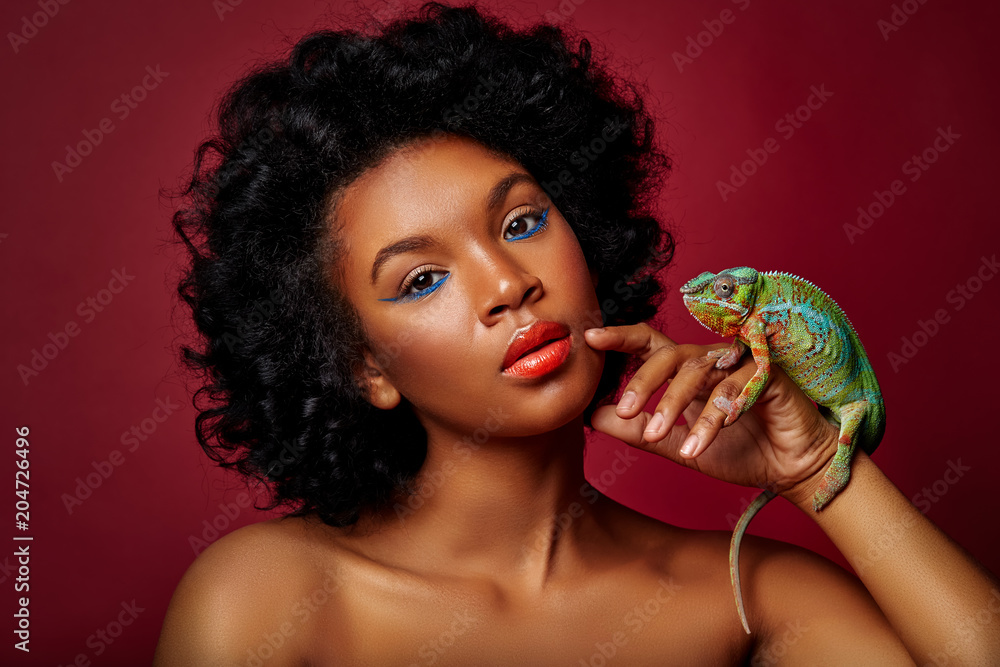 Wall mural beautiful woman holding chameleon