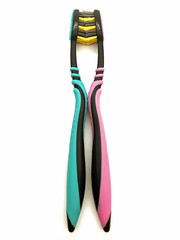 Obraz na płótnie Canvas Two toothbrushes kissing black with blue and black with pink on white background