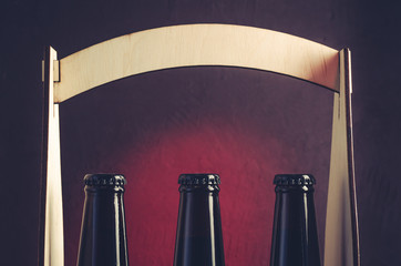 neck of beer bottles in a wooden box/neck of beer bottles in a wooden box. Selective focus