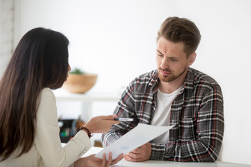 Unconvinced skeptical client looking doubtful about rejecting deal listening to manager, uncertain distrustful investor not impressed with offer of business partner at meeting suspecting fraud