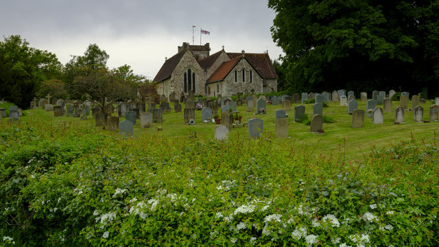Spring time view on an overcast day from the north gate leading from the Lythes footpath of St Mary's church, Selborne, Hampshire, UK