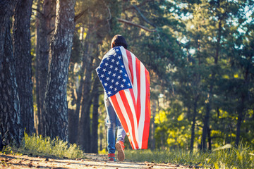 happy smiling young woman with national american flag outdoors