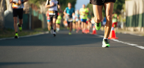 Marathon running race, people feet on city road