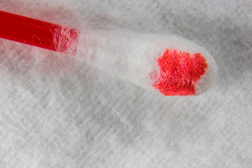 Hygienic stick in the blood is on a cotton pad macro