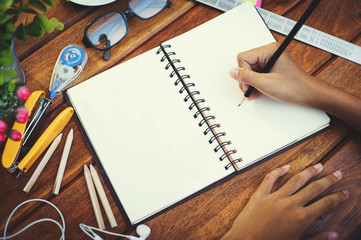 young female hands writing empty open notebook