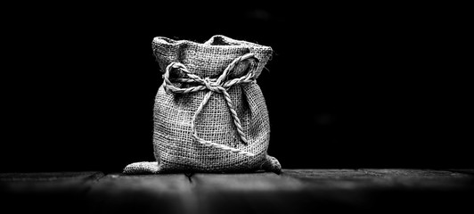 empty woven bag isolate put on wooden table is on black background