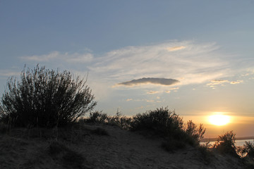 the setting sun reflected in the pond