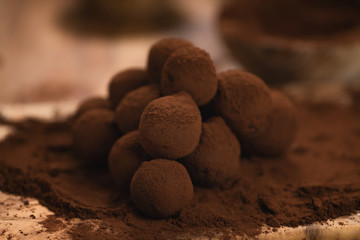 craft chocolate truffles on wooden board with cocoa powder