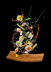 Zelfklevend Fotobehang Flying sushi pieces on black background © Jag_cz