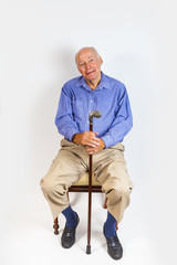 happy elderly man sitting in a chair