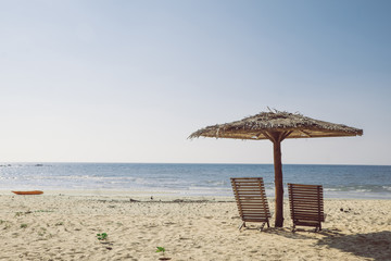 Chair, umbrella, beach seaside that evening air.
