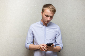 guy in shirt looking at mobile phone