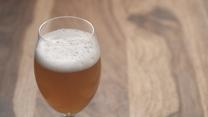closeup apple cider in a wine glass on wood table