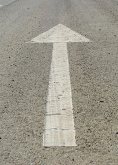 forward white arrow on the road