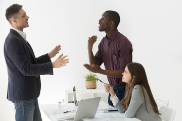 Diverse african and caucasian colleagues disputing at group meeting, multiracial partners having...