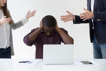 Angry overwhelmed african businessman frustrated with discrimination at work, hates stressful job,...