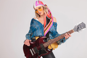 seductive rock woman with yellow glasses holding her electric guitar