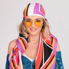 portrait of beautiful woman with colored headscarf and yellow sunglasses