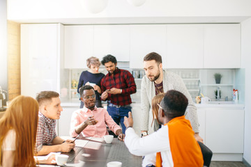 close up portrait of mixed race volunteers meeting in the informal setting