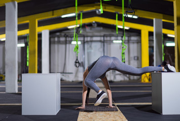 Fototapeta na wymiar woman working out gymnastic exercise on fit boxes