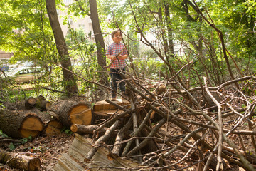 Child building a cabin with tree branches