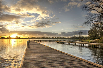 Sunset over lake Kralingse plas and the Rotterdam skyline as seen from one of the wooden walkways