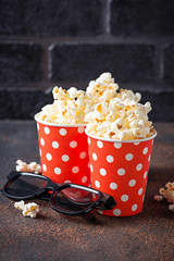 Popcorn with 3d glasses on dark background