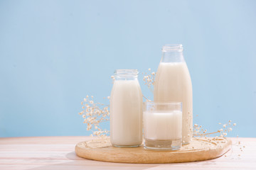 Dairy products. Bottle with milk and glass of milk on wooden table