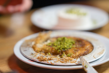 Turkish dessert Kanafeh with pistachio clipping path. Selective focus