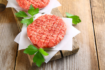 Raw minced meat for home made grill burgers cooking with spaces and herbs.