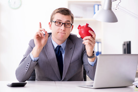 Young Employee With Piggybank In Pension Savings Concept