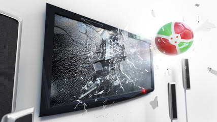 Soccer ball with the flag of Burundi kicked through a shattering tv screen.(3D rendering series)
