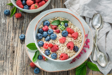 Top view of oat flakes with fresh blueberries and raspberries