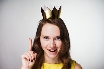 beautiful young woman in a yellow dress lifted her finger up, an idea appeared, smiling, on her...