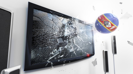 Soccer ball with the flag of Swaziland kicked through a shattering tv screen.(3D rendering series)