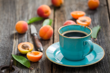 Closeup of delicious coffee and plums in summer garden