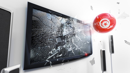 Soccer ball with the flag of Tunisia kicked through a shattering tv screen.(3D rendering series)